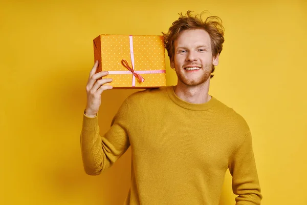 Cheerful Redhead Man Carrying Gift Box Shoulder While Standing Yellow — Photo