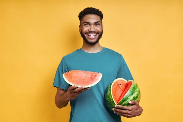 Young African Man Holding Watermelon Smiling While Standing Yellow Background — Stock Photo, Image