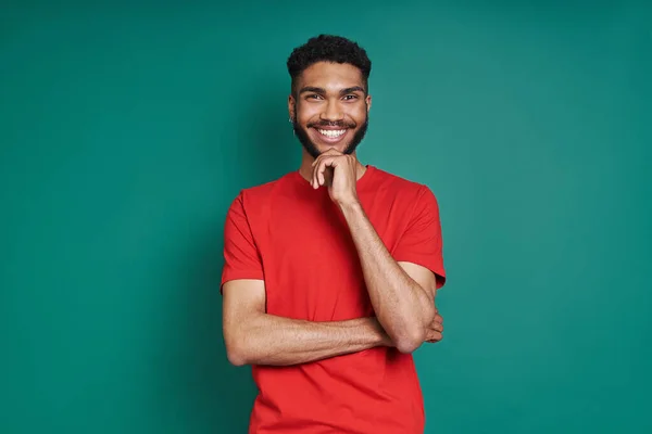 Happy African Man Holding Hand Chin Smiling While Standing Green — Stock fotografie