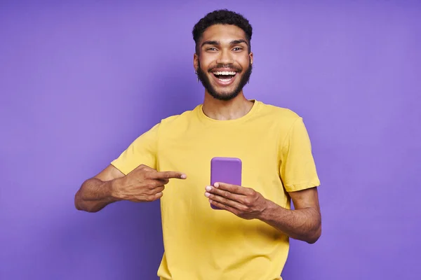 Happy African Man Pointing His Smart Phone While Standing Purple — 图库照片