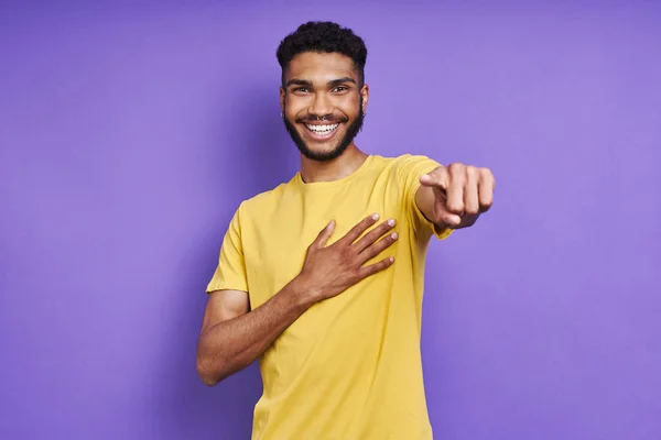 Cheerful Man Holding Hand Heart Pointing Camera While Standing Purple — Stockfoto