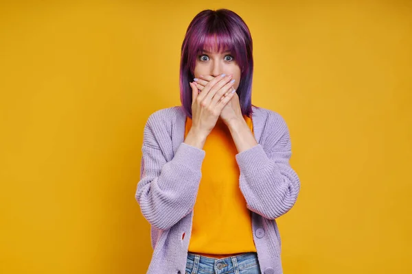 Shocked Young Woman Covering Mouth Hands While Standing Yellow Background — Photo