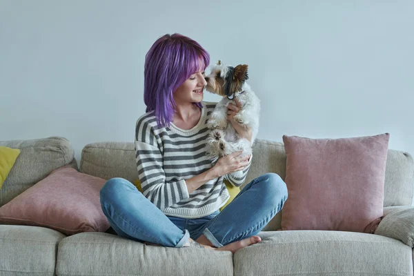 Cheerful Teenage Girl Carrying Her Little Dog While Relaxing Couch — Fotografia de Stock