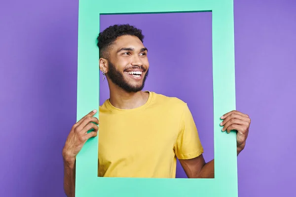 Cheerful African Man Looking Picture Frame While Standing Purple Background — Foto Stock