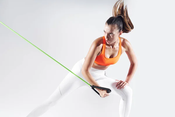 Concentrated Young Woman Exercising Resistance Band White Background — Stock fotografie