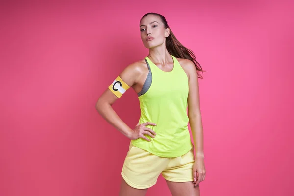 Confident Woman Sports Clothing Wearing Captain Band While Standing Pink — 图库照片