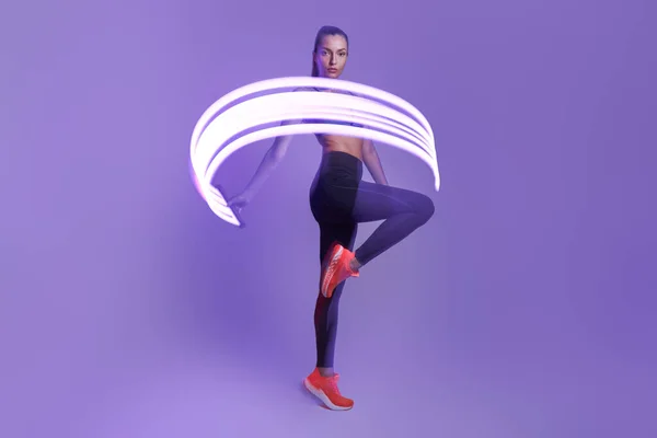 Confident Young Woman Sports Clothing Moving Violet Background — Foto de Stock