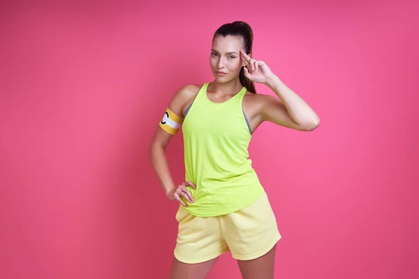 Confident Woman Sports Clothing Wearing Captain Band Gesturing Pink Background — Foto Stock