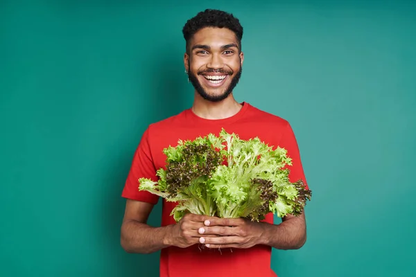 Cheerful African Man Carrying Bunch Lettuce While Standing Green Background — Stock Photo, Image