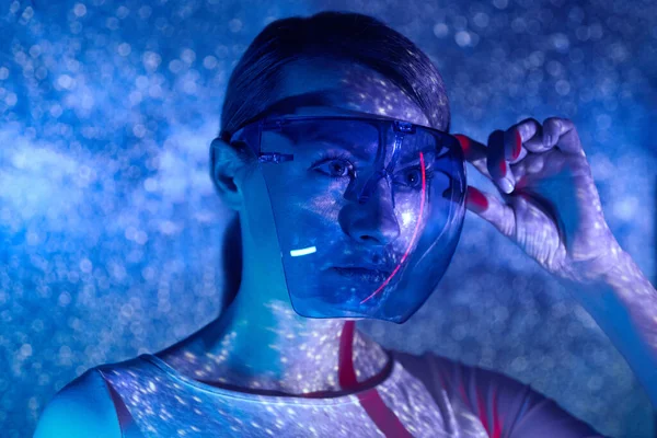 Confident Young Woman Adjusting Futuristic Glasses Colorful Background — 图库照片