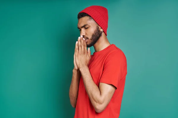 Young African Man Holding Hands Clasped Face While Standing Green — Foto de Stock