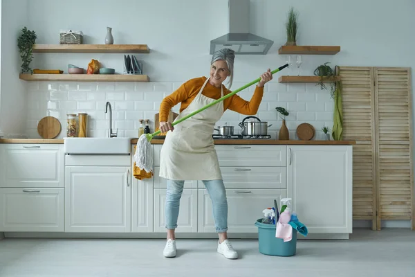 Playful Senior Woman Carrying Mop While Standing Domestic Kitchen — Stock Fotó