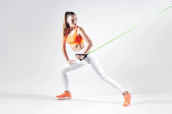 Beautiful Woman Sports Clothing Using Resistance Band While Exercising White — Photo