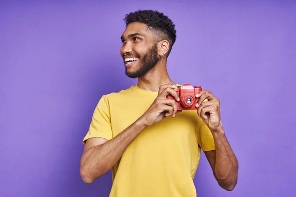 Handsome African Man Holding Photo Camera Smiling While Standing Purple — Stockfoto