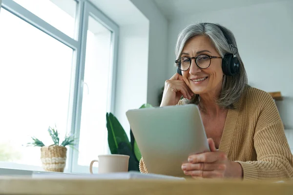 Cheerful Senior Woman Using Digital Tablet While Working Home — Φωτογραφία Αρχείου