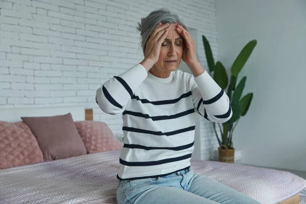 Frustrated Senior Woman Suffering Headache While Sitting Bed Home — Fotografia de Stock