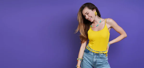 Relaxed Young Woman Smiling While Standing Purple Background — стоковое фото