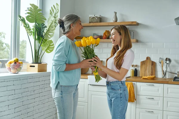 Happy Senior Mother Receiving Bunch Tulips Her Daughter While Standing — Stock Photo, Image