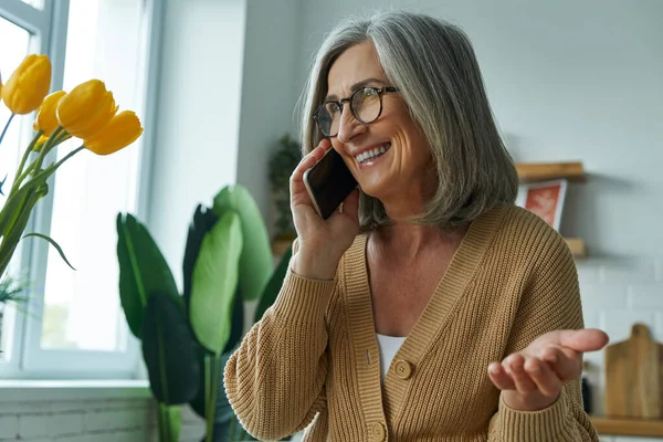 Happy Senior Woman Talking Mobile Phone Gesturing While Relaxing Home — Stock Photo, Image