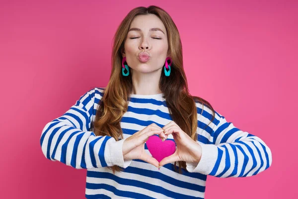 Beautiful Young Woman Gesturing Heart Shape Blowing Kiss Colored Background — Fotografia de Stock