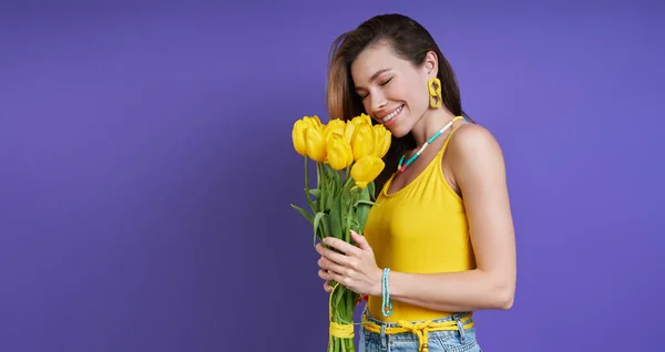 Attractive Young Woman Smelling Bunch Flowers Purple Background — Foto de Stock