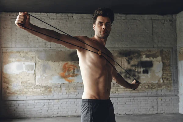 Confident Young Man Exercising Resistance Band Gym — Foto de Stock