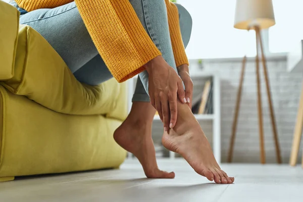 Close Woman Massaging Her Tired Feet While Sitting Couch Home — Stockfoto