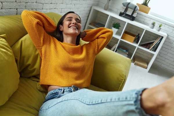 Joyful Young Woman Holding Hands Head While Sitting Couch Home — Foto de Stock