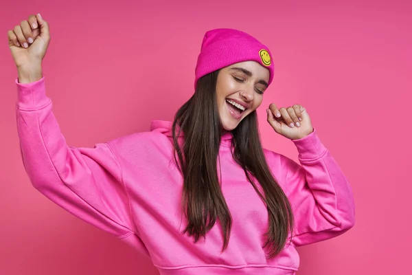 Happy Young Woman Hooded Shirt Funky Hat Dancing Pink Background — Stock Photo, Image