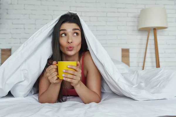 Dreamful Woman Looking Out Blanket Holding Coffee Cup While Lying — Stock Fotó