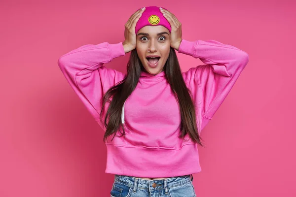 Surprised Young Woman Hooded Shirt Holding Head Hands Pink Background — Zdjęcie stockowe