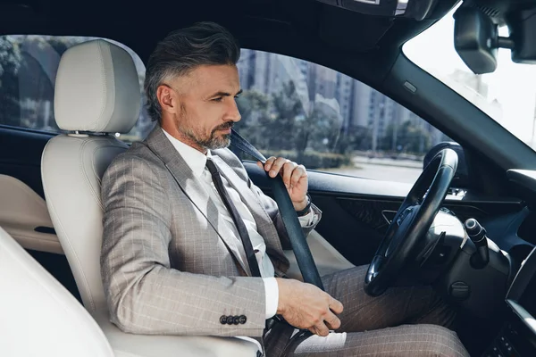 Confident Man Fastening Seat Belt While Sitting Front Seat Car — Foto Stock