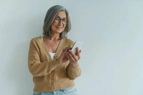 Elegant Senior Woman Using Smart Phone Smiling While Standing White — Stock Photo, Image