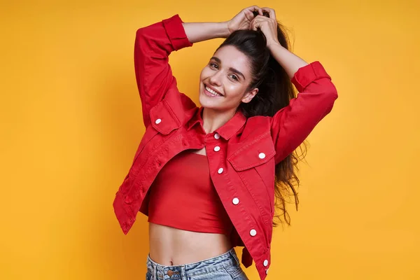 Beautiful Young Woman Adjusting Her Hair Yellow Background — ストック写真