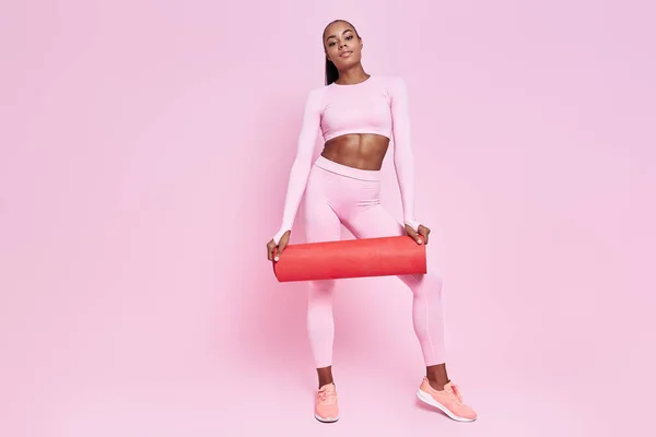 Attractive African Woman Sports Clothing Carrying Exercise Mat Pink Background —  Fotos de Stock