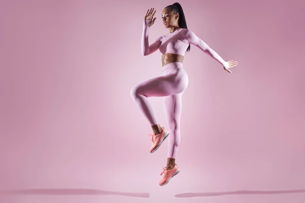 Beautiful Young Woman Sports Clothing Jumping Pink Background — 图库照片