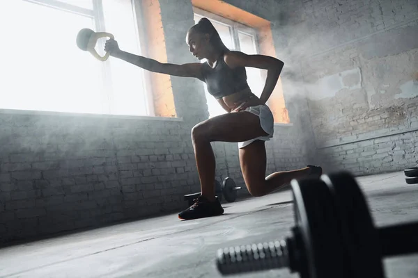 Concentrated Young African Woman Exercising Kettlebell Gym — Foto de Stock