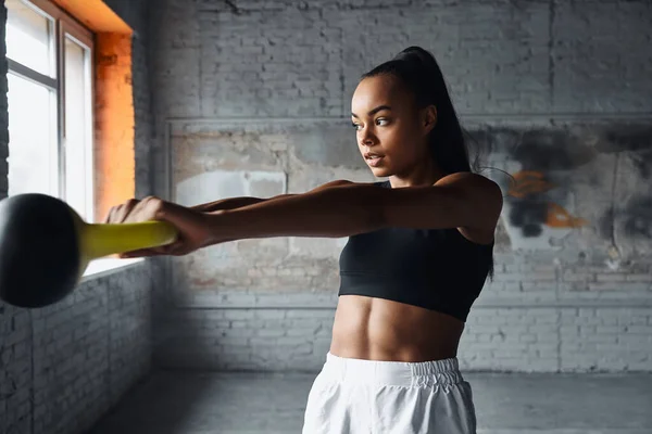 Concentrated Young African Woman Exercising Kettlebell Gym —  Fotos de Stock