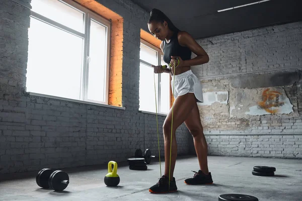 Attractive Young African Woman Examining Jumping Rope While Standing Gym — Foto de Stock