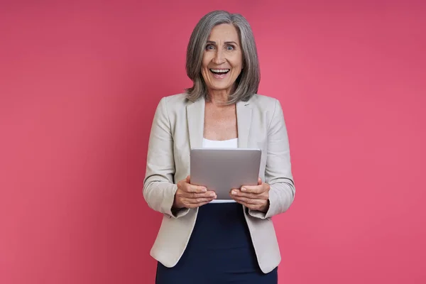 Excited Senior Woman Formalwear Holding Digital Tablet While Standing Pink — Foto de Stock