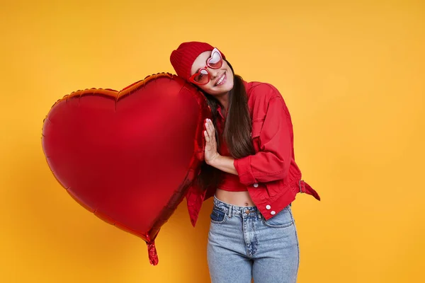 Cheerful Young Woman Holding Heart Shape Balloon Yellow Background — Fotografia de Stock