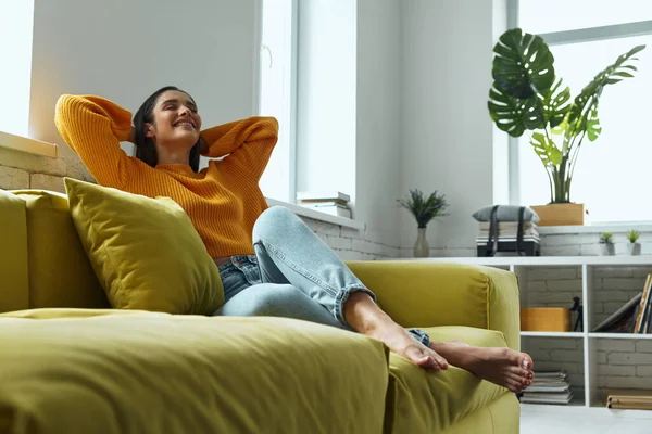 Relaxed Young Woman Holding Hands Head While Sitting Couch Home — Stok fotoğraf