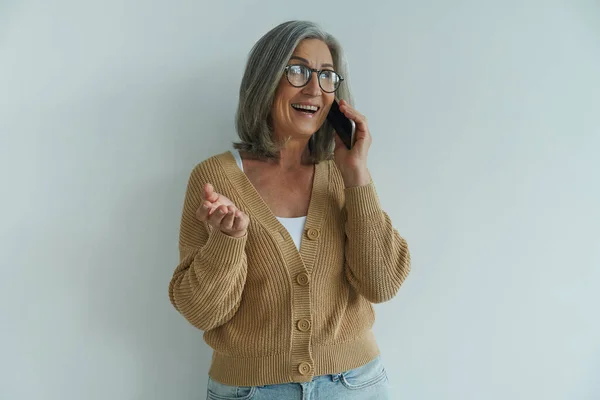 Happy Senior Woman Talking Mobile Phone Gesturing While Standing White — Foto de Stock