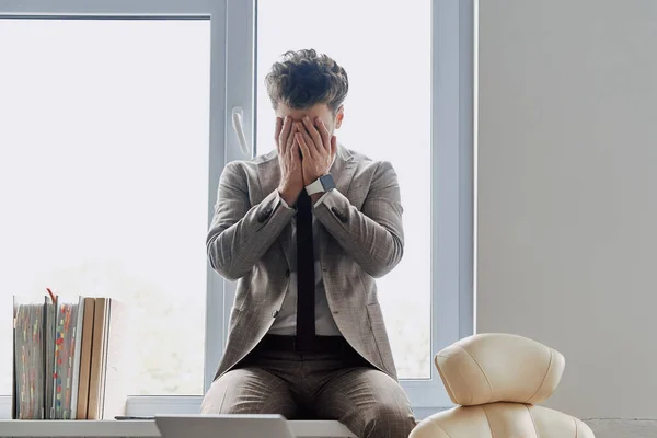 Depressed Young Man Covering Face Hands While Sitting Window Sill — Foto de Stock