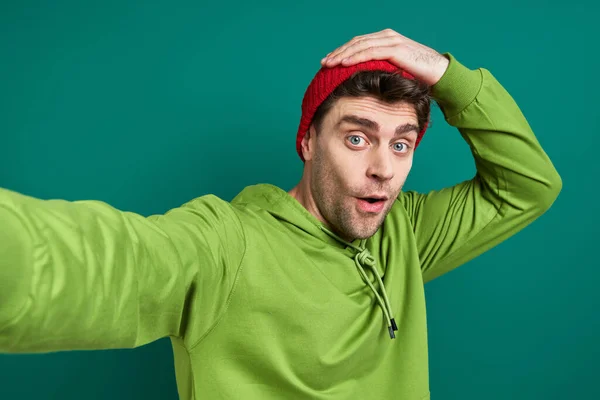 Surprised Young Man Making Selfie While Standing Green Background — Stockfoto