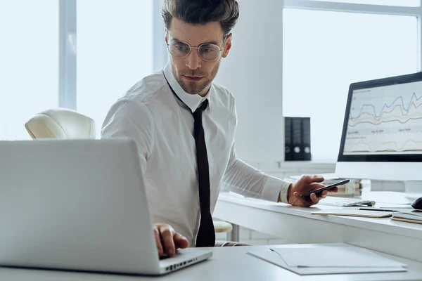 Confident Young Man Busy Working While Sitting Desk Office — Stock Fotó