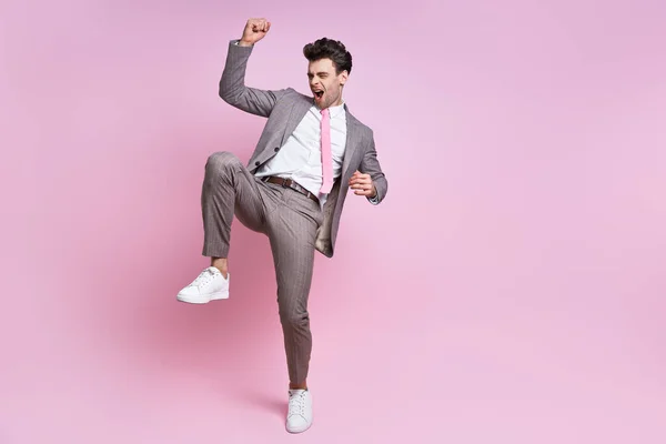 Excited Young Man Full Suit Gesturing While Standing Pink Background — Foto Stock