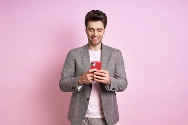 Happy Young Man Suit Using Smart Phone While Standing Pink — Foto Stock
