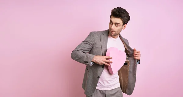 Playful Young Man Suit Hiding Paper Heart Jacket While Standing — 图库照片