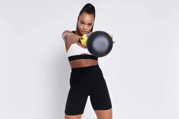 Attractive Young African Woman Exercising Kettlebell White Background — Foto de Stock